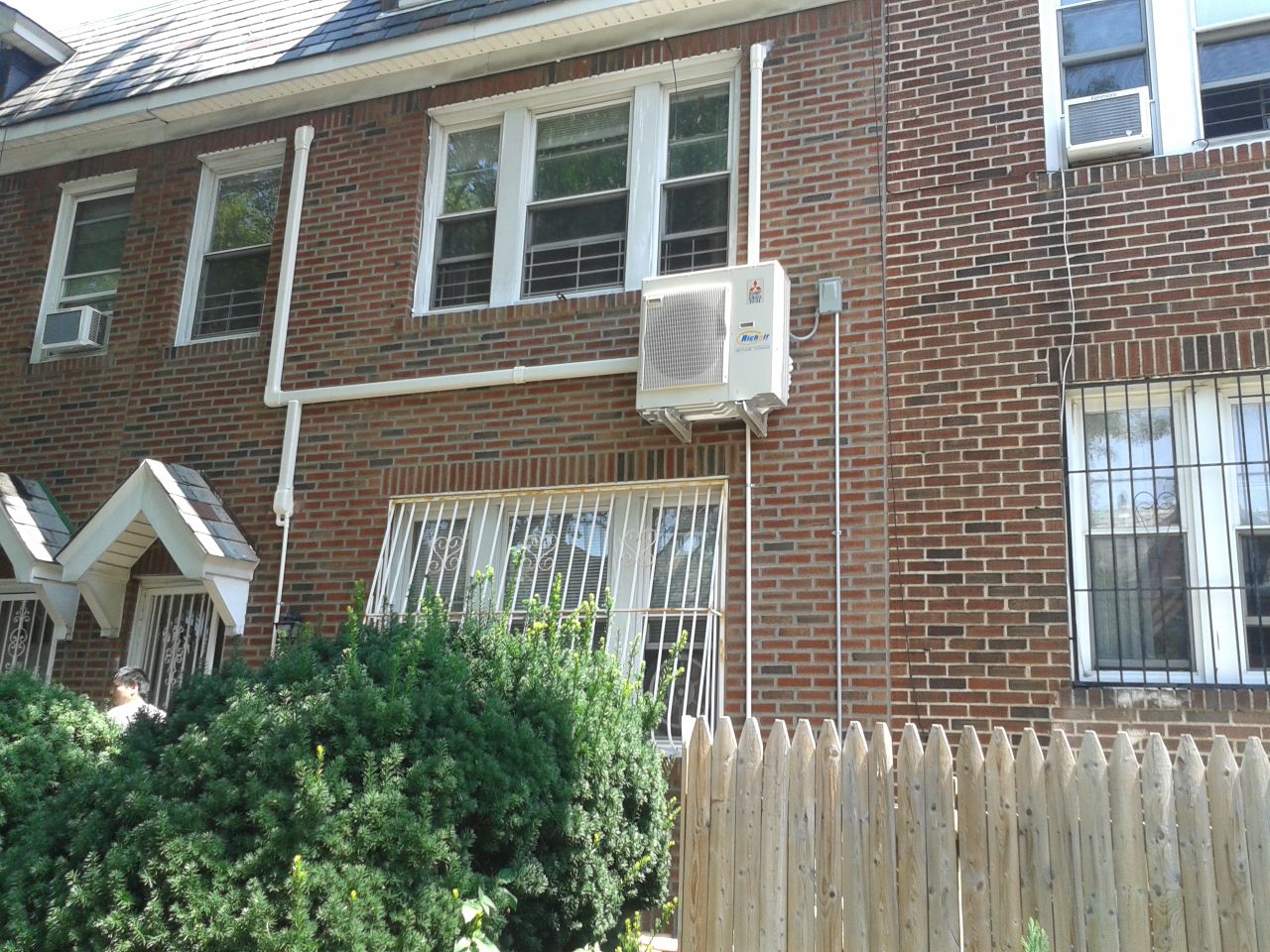Mini split outdoor unit installed on the wall in Flushing, NY