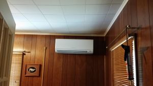 Indoor unit installed on wooden wall paneling in New York
